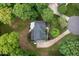 A high angle displays the home, driveway and mature trees of the property at 7000 Millstone Ridge Ct, Raleigh, NC 27614
