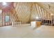 Unfinished attic space with exposed wooden framing, insulation, and plywood flooring at 7000 Millstone Ridge Ct, Raleigh, NC 27614