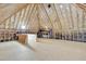 Unfinished attic space with exposed wooden framing, insulation, and plywood flooring at 7000 Millstone Ridge Ct, Raleigh, NC 27614