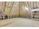 Unfinished attic space with exposed wooden framing, insulation, and plywood flooring at 7000 Millstone Ridge Ct, Raleigh, NC 27614