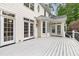 Exterior home view with white deck and multiple glass doors leading into the backyard at 7000 Millstone Ridge Ct, Raleigh, NC 27614