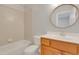 Bathroom featuring a bathtub, toilet, vanity, and a round mirror at 7000 Millstone Ridge Ct, Raleigh, NC 27614