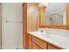 Bright bathroom featuring a vanity with built-in storage and a framed mirror above the sink at 7000 Millstone Ridge Ct, Raleigh, NC 27614
