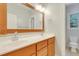 Bright bathroom featuring double sinks, wood accents, and neutral finishes at 7000 Millstone Ridge Ct, Raleigh, NC 27614