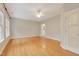 Large, bright bedroom with hardwood flooring, a ceiling fan and direct bathroom access at 7000 Millstone Ridge Ct, Raleigh, NC 27614