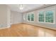 Spacious bedroom featuring hardwood floors, bright windows, and a modern ceiling fan at 7000 Millstone Ridge Ct, Raleigh, NC 27614