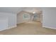 Spacious carpeted bonus room with neutral walls, multiple windows, and a vaulted ceiling at 7000 Millstone Ridge Ct, Raleigh, NC 27614