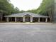 Community clubhouse with neutral paint, gray roof, and pillars on a cloudy day at 7000 Millstone Ridge Ct, Raleigh, NC 27614