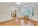 Bright dining room featuring a bay window, hardwood flooring, and seamless flow to the entryway at 7000 Millstone Ridge Ct, Raleigh, NC 27614