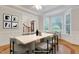 Bright dining room featuring a modern table, a bay window, and seamless flow to the entryway at 7000 Millstone Ridge Ct, Raleigh, NC 27614