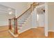 Staircase with decorative wrought iron railing and hardwood floors throughout the entry at 7000 Millstone Ridge Ct, Raleigh, NC 27614