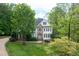 Charming two-story home with stone accents and a well-manicured lawn surrounded by mature trees at 7000 Millstone Ridge Ct, Raleigh, NC 27614