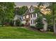 Stone and siding home with lush landscaping, great curb appeal on a sunny day at 7000 Millstone Ridge Ct, Raleigh, NC 27614