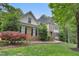 Beautifully landscaped front yard complements this two-story home with a stone facade at 7000 Millstone Ridge Ct, Raleigh, NC 27614