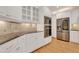 Kitchen featuring white cabinets, stainless steel appliances, and dark granite countertops at 7000 Millstone Ridge Ct, Raleigh, NC 27614
