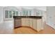 Eat-in kitchen space featuring a stainless steel dishwasher and an island with black countertops at 7000 Millstone Ridge Ct, Raleigh, NC 27614