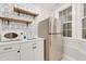 Charming kitchenette featuring geometric wallpaper, stainless fridge, and stylish retro microwave at 7000 Millstone Ridge Ct, Raleigh, NC 27614