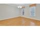 Bright room with natural light, hardwood flooring, and traditional window valances at 7000 Millstone Ridge Ct, Raleigh, NC 27614