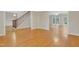Open-concept living space with hardwood floors, staircase, and natural light from French doors at 7000 Millstone Ridge Ct, Raleigh, NC 27614