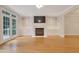 Bright living room with hardwood floors, fireplace, built-in shelves, and access to the outside at 7000 Millstone Ridge Ct, Raleigh, NC 27614