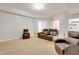 This living room features comfortable leather seating, neutral walls and carpet, and recessed lighting at 7000 Millstone Ridge Ct, Raleigh, NC 27614