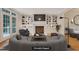 Inviting living room featuring a fireplace, built-in shelving, and comfortable seating at 7000 Millstone Ridge Ct, Raleigh, NC 27614
