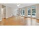 Spacious living room with hardwood flooring, a ceiling fan, and French doors leading to a patio at 7000 Millstone Ridge Ct, Raleigh, NC 27614