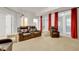 Living room featuring recessed lighting, carpet, leather seating, and doorways with red curtains at 7000 Millstone Ridge Ct, Raleigh, NC 27614
