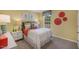 Cozy bedroom with natural light, vibrant decor, and comfortable bed and furnishings at 701 Holstein Dairy Way, Wake Forest, NC 27587
