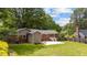 A brick exterior complemented by a well-manicured lawn and a concrete patio for outdoor enjoyment at 702 Wedgewood Ave, Zebulon, NC 27597
