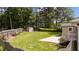 Well-maintained backyard features a lush lawn, storage shed, mature trees, and a concrete patio perfect for relaxing at 702 Wedgewood Ave, Zebulon, NC 27597