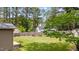 Spacious, verdant backyard with a tall privacy fence, garden, and mature trees offering ample shade at 702 Wedgewood Ave, Zebulon, NC 27597