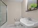 Well-lit bathroom featuring a white vanity, modern fixtures, and a glass-enclosed shower at 702 Wedgewood Ave, Zebulon, NC 27597