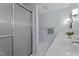 Well-lit bathroom with a glass-enclosed shower, dual vanity, and modern fixtures at 702 Wedgewood Ave, Zebulon, NC 27597