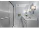 Bathroom featuring double vanity, modern lights, and a glass-enclosed shower for a bright space at 702 Wedgewood Ave, Zebulon, NC 27597