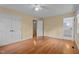 Bedroom with hardwood floors, neutral walls, overhead fan, and doorways leading to other rooms at 702 Wedgewood Ave, Zebulon, NC 27597