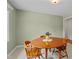 Cozy breakfast nook with a round wooden table with seating for four near a bright window at 702 Wedgewood Ave, Zebulon, NC 27597