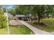 Charming single-story home featuring a covered carport and a well-maintained lawn with mature trees at 702 Wedgewood Ave, Zebulon, NC 27597