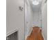 Bright hallway with hardwood floors, white walls, and doorways leading to various rooms at 702 Wedgewood Ave, Zebulon, NC 27597