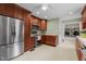 Modern kitchen with stainless steel appliances and rich wood cabinets with access to the laundry room at 702 Wedgewood Ave, Zebulon, NC 27597