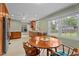 Bright kitchen with stainless steel appliances, wooden cabinetry, a round breakfast table and a large window at 702 Wedgewood Ave, Zebulon, NC 27597