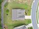Aerial view of a home featuring a gray roof, driveway, and a well-maintained yard in a residential neighborhood at 704 Long Lake Dr, Fuquay Varina, NC 27526