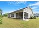Backyard view of home featuring siding, a screened-in porch, and landscaping at 704 Long Lake Dr, Fuquay Varina, NC 27526