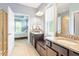 Main bathroom featuring double vanities, tile floors, and walk-in shower at 704 Long Lake Dr, Fuquay Varina, NC 27526