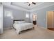 Comfortable primary bedroom with tray ceiling, neutral carpet, and en-suite bathroom at 704 Long Lake Dr, Fuquay Varina, NC 27526