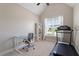Bright bedroom featuring a desk, bookshelf, and treadmill for a convenient workout space at 704 Long Lake Dr, Fuquay Varina, NC 27526
