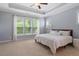 Bright, spacious main bedroom with tray ceiling, large windows, and neutral decor at 704 Long Lake Dr, Fuquay Varina, NC 27526