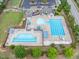 High angle view of a community pool and recreation area with multiple pools, playground, and seating areas at 704 Long Lake Dr, Fuquay Varina, NC 27526