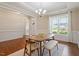 Open dining room featuring hardwood floors, wainscoting, and natural light at 704 Long Lake Dr, Fuquay Varina, NC 27526