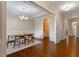 Elegant dining room featuring hardwood floors, wainscoting, and a modern chandelier at 704 Long Lake Dr, Fuquay Varina, NC 27526
